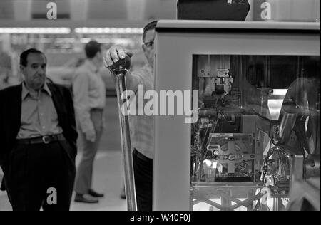 One armed bandits fruit machine, slot machines, man playing  gambling on Big Bertha a giant one arm bandit  1969, Reno Nevada Casino. USA 60s US HOMER SYKES Stock Photo