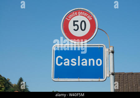 Close up picture of Caslano village road sign with a 50km general speed limit street sign located in the Lugano region in Ticino, Switzerland Stock Photo