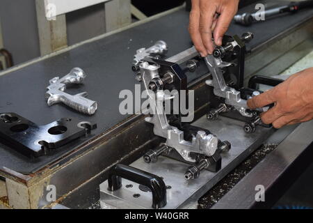 Preparation of parts of airbrush and spray gun for CNC lathe machining. Parts for CNC machine. Stock Photo