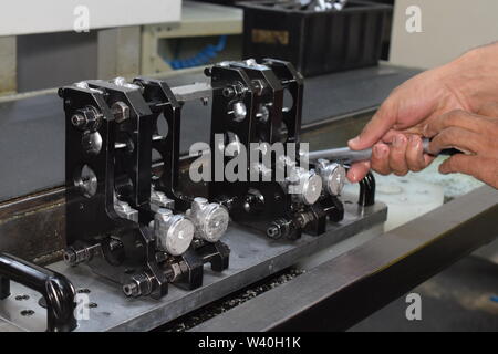 Preparation of parts of airbrush and spray gun for CNC lathe machining. Parts for CNC machine. Stock Photo
