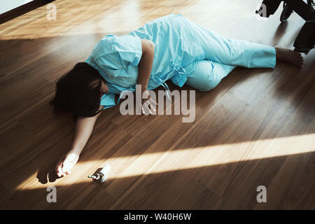 Asian woman committing suicide by overdosing on medication. Close up of overdose pills and addict. Stock Photo
