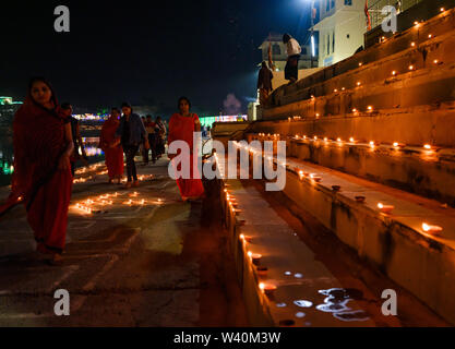 PUSHKAR, INDIA - CIRCA NOVEMBER 2018: Woman walking in the Pushkar Ghats during the opening ceremonies of the Camel Fair. It is one of the world's lar Stock Photo