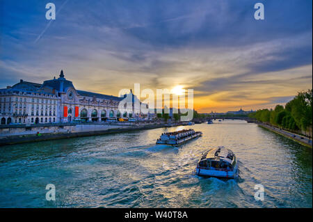 Paris, France - April 21, 2019 - A view of the Musee d'Orsay along the River Seine at sunset in Paris, France.
