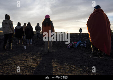 Mauna Kea, Hawaii, USA. 18th July, 2019. Activists gather for a sunrise ceremony on the fourth day of protesting a massive telescope that is planned to be built on Mauna Kea, a mountain considered sacred to many Native Hawaiians. Credit: Ronit Fahl/ZUMA Wire/Alamy Live News Stock Photo