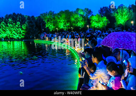 Jilin, Jilin, China. 19th July, 2019. Jilin, CHINA-The musical fountain lighting show in Jingyuetan national forest park in Changchun, capital of northeast China's Jilin province, opens on July 1, 2019.Music fountain waterscape light show is located in the goddess square at the main entrance of jingyuetan, taking the statue of the goddess of the clear moon as the central point, composed of fountain, LED beam light, LED full color tree light, LED full color wash wall light, pattern light, etc., which can combine hundreds of action forms. Credit: SIPA Asia/ZUMA Wire/Alamy Live News Stock Photo