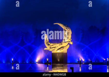 Jilin, Jilin, China. 19th July, 2019. Jilin, CHINA-The musical fountain lighting show in Jingyuetan national forest park in Changchun, capital of northeast China's Jilin province, opens on July 1, 2019.Music fountain waterscape light show is located in the goddess square at the main entrance of jingyuetan, taking the statue of the goddess of the clear moon as the central point, composed of fountain, LED beam light, LED full color tree light, LED full color wash wall light, pattern light, etc., which can combine hundreds of action forms. Credit: SIPA Asia/ZUMA Wire/Alamy Live News Stock Photo