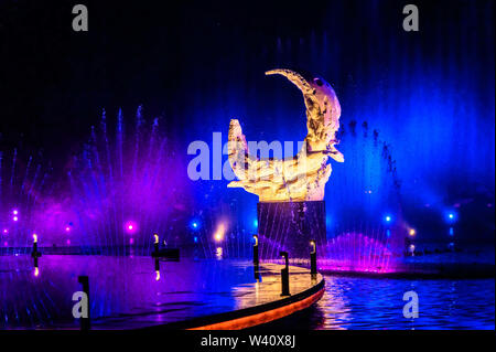 Jilin, Jilin, China. 19th July, 2019. Jilin, CHINA-The musical fountain lighting show in Jingyuetan national forest park in Changchun, capital of northeast China's Jilin province, opens on July 1, 2019.Music fountain waterscape light show is located in the goddess square at the main entrance of jingyuetan, taking the statue of the goddess of the clear moon as the central point, composed of fountain, LED beam light, LED full color tree light, LED full color wash wall light, pattern light, etc., which can combine hundreds of action forms. Credit: SIPA Asia/ZUMA Wire/Alamy Live News Stock Photo