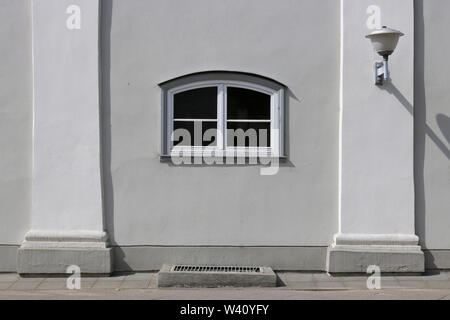 The white plastic arch small modern  window,  lantern and columns in an old but renovated house Stock Photo
