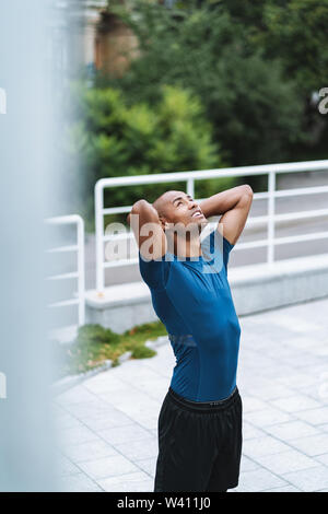 Image of handsome young strong sports man posing outdoors. Stock Photo