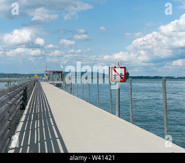 Altnau, TG / Switzerland - 14. July 2019: close up view of  the long pier at Altnau on Lake Constance with a no swimming sign because of passenger shi Stock Photo