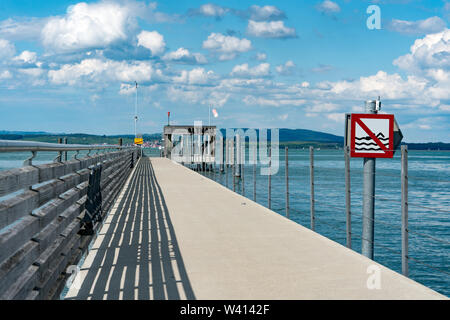 Altnau, TG / Switzerland - 14. July 2019: close up view of  the long pier at Altnau on Lake Constance with a no swimming sign because of passenger shi Stock Photo