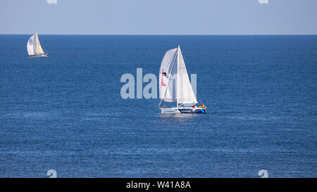 Egmond aan Zee, Netherlands - July 18, 2019: two sailing boats on the North Sea in sunlight Stock Photo