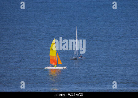 Egmond aan Zee, Netherlands - July 18, 2019: two sailing boats on the North Sea in sunlight Stock Photo