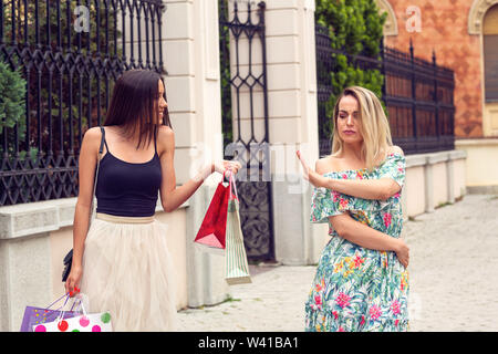 two young girl arguing at shopping in the city. Stock Photo