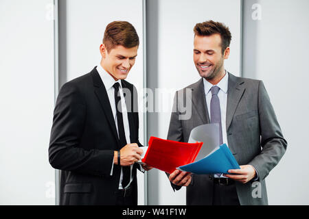 Two professionals talking and looking at files Stock Photo
