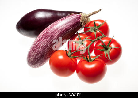 Fresh eggplants and tomatos over white background Stock Photo