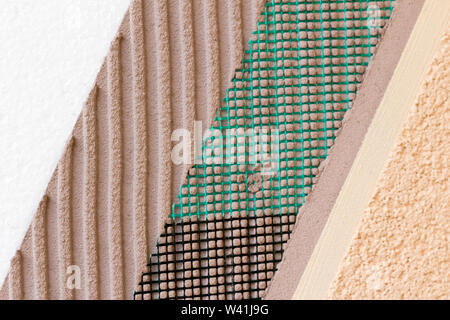 Closeup of layers on wall insulation, styrofoam mesh, plaster, cement, mortar Stock Photo