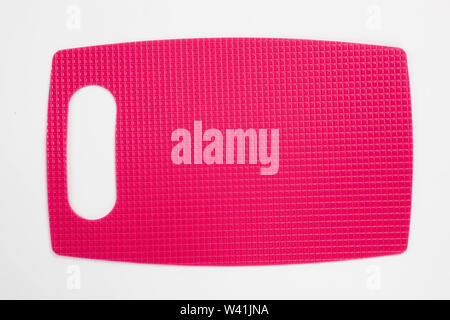 Pink plastic kitchen cutting board isolated on white background Stock Photo