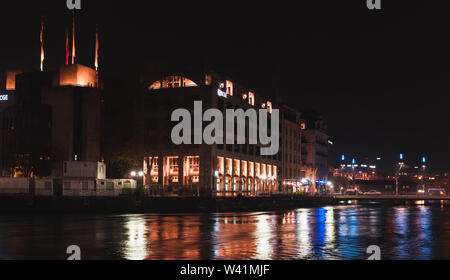 Geneva, Switzerland - November 24, 2016: Pont de la Machine. Night cityscape with illuminated facades and reflections in Rhone river water. Central di Stock Photo