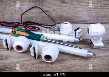 Spare parts for the repair of the lamp are on a wooden background Stock Photo