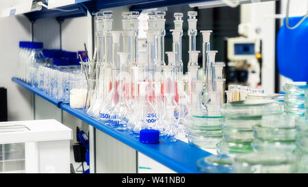Laboratory glassware on the shelf in the laboratory. Stock Photo