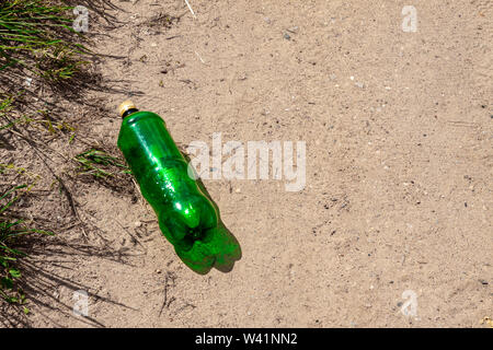 Empty plastic bottle lying on the ground. Stock Photo