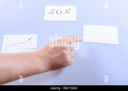 The finger on the hand shows a blank sticker. Template. Stock Photo