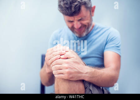 Man with knee pain close up. Pain relief concept Stock Photo