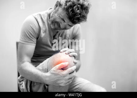 Man with knee pain close up. Pain relief concept Stock Photo