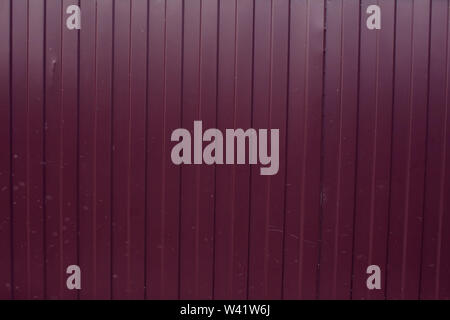 Red color metal sheet material roller gate or door with horizontal lines Stock Photo