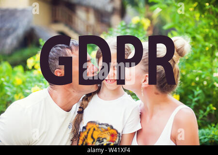 Mother and father kiss their child. GDPR - their face behind the inscription General Data Protection Regulation. Cyber security and privacy. hide the Stock Photo