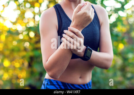 Woman have a wrist pain. Healthcare, medicine and people concept Stock Photo