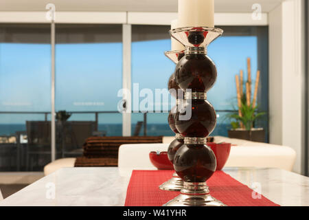 A closeup of two beautiful glass candle holders placed on a dining table Stock Photo