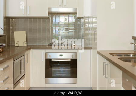 Small modern kitchen with built in stove and microwave Stock Photo