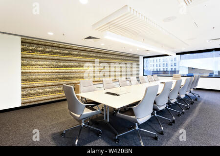 Conference room with chairs and large office window under flashing light Stock Photo