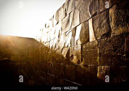 Morning sunlight spread on the wet and stone wall shining Stock Photo