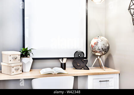 Closeup of a modern study room with  globe and boxes beside 3d letters and opened book on the wooden light Stock Photo