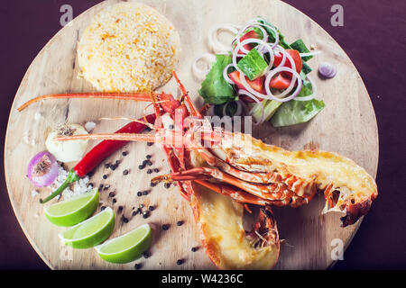 A luxury dish of lobster roasted and decorated with many items of vegetable Stock Photo