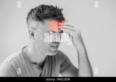 Handsome young man suffering from headache Stock Photo