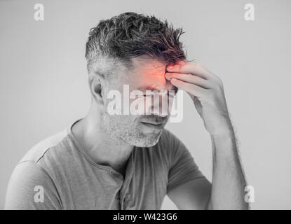 Handsome young man suffering from headache Stock Photo