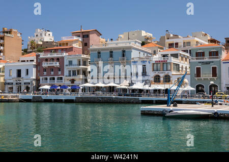 Colourful restaurants, bars and cafes along the waterfront promenade in Agios Nikolaos, Crete, Greece Stock Photo