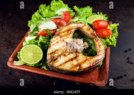 Grilled Fish Fillet with Vegetables in the plate Stock Photo
