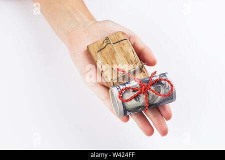 Money in a mousetrap with a hand. On a white background. Stock Photo