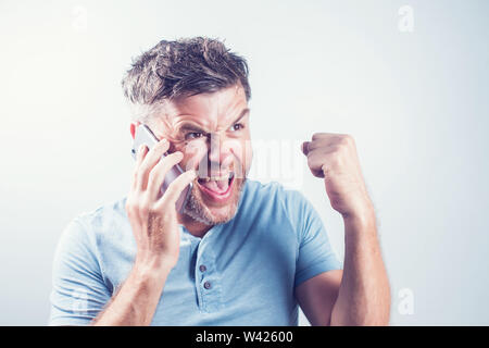 Handsome young man using mobile phone feel happy Stock Photo