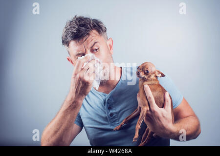 Man having pet allergy symptoms : runny nose, asthma Stock Photo