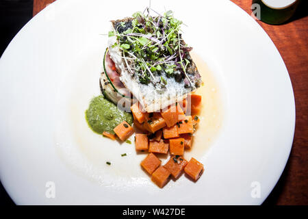 Papaya mixed onion salad on plate, hot food including meat and vegetable, very tasty look, background is black color, dining table of a luxury hotel o Stock Photo