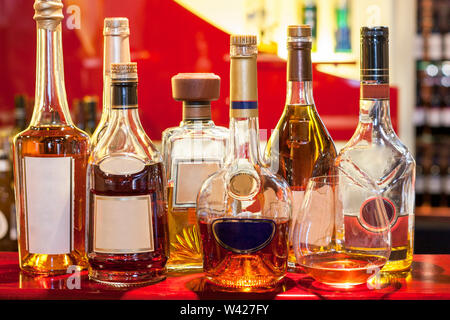 Wine bottles with modern look, inside at a hotel, colorized photograph including perfect lights, very expensive drinks of luxury restaurant. Stock Photo