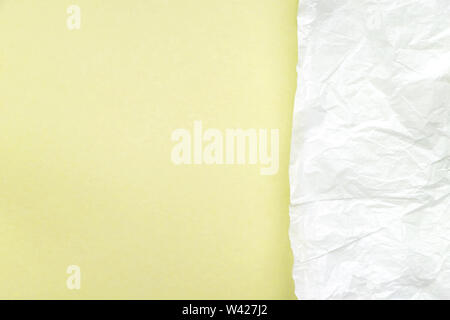 Crumpled white parchment paper on bright blue, turquoise background top view. Rough, wrinkled, damaged paper texture. Abstract design, creased, aged style art, wallpaper, backdrop, background Stock Photo