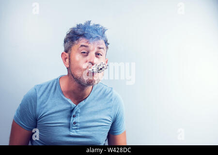 Young man with many cigarettes in his mouth Stock Photo