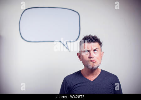 Portrait of a young man with a empty speech bubble over his head Stock Photo